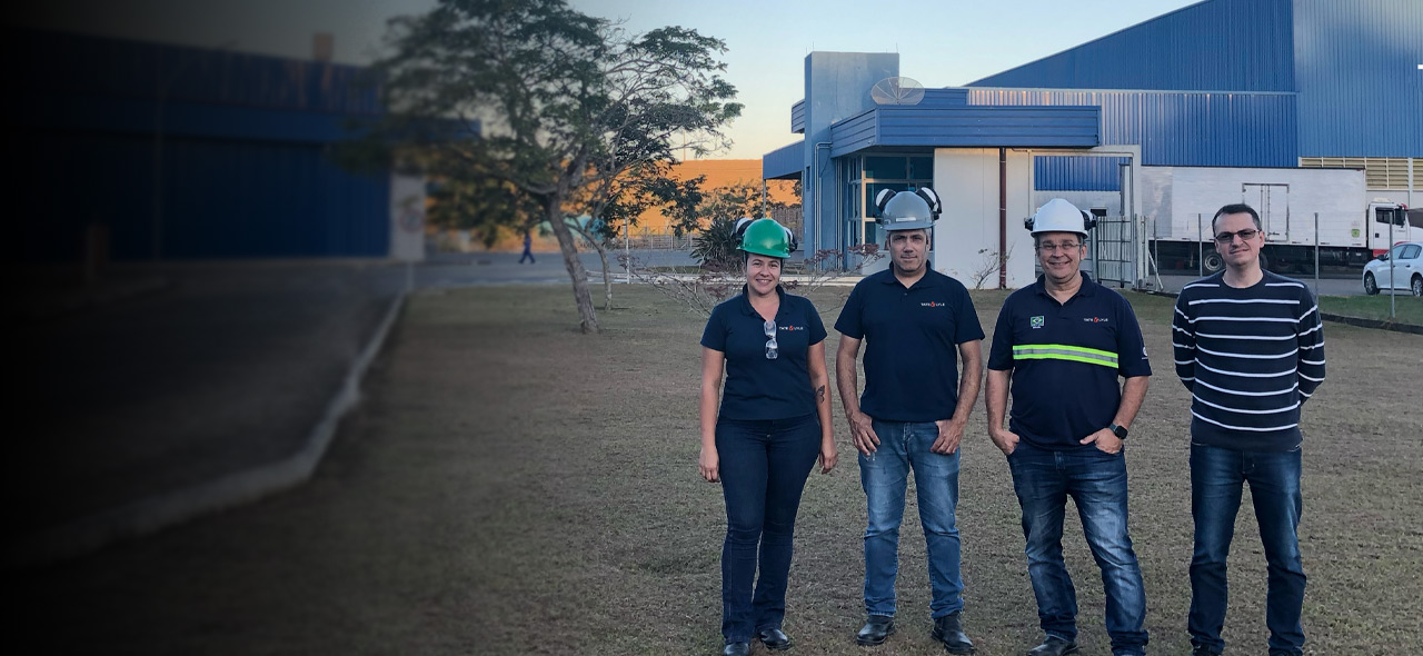 Four colleagues standing in front of Guarani site, Brazil