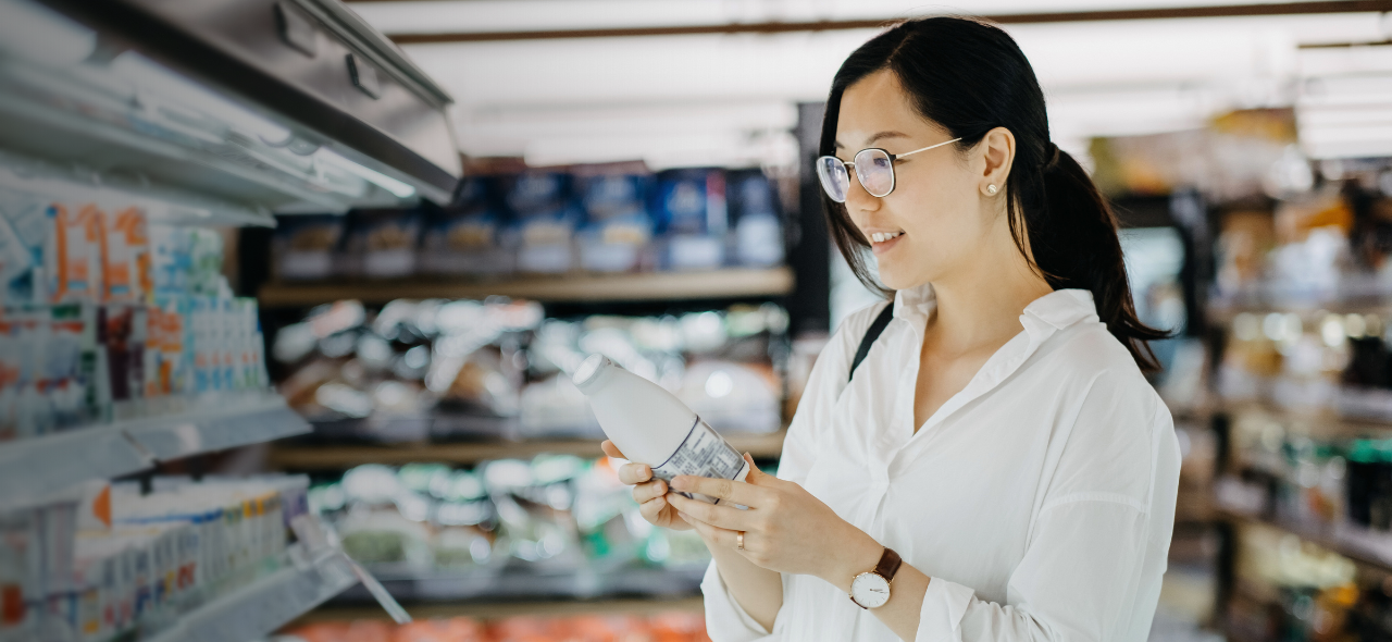 Woman looking at dairy product on supermarket