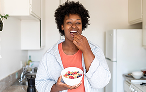 Smiling woman eating a fortified breakfast cereal