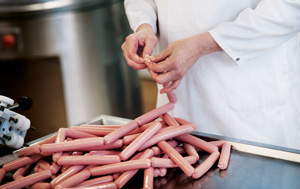 Scientist tying plant-based sausages