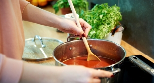 Woman cooking a soup