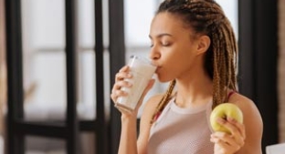 Woman sipping fortified milk drink