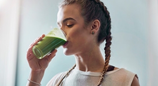 Girl drinking green fibre fortified smoothie