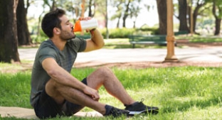 Outdoor exerciser drinking from sports bottle