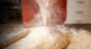 Bakery report - hands clapping flour over bread dough